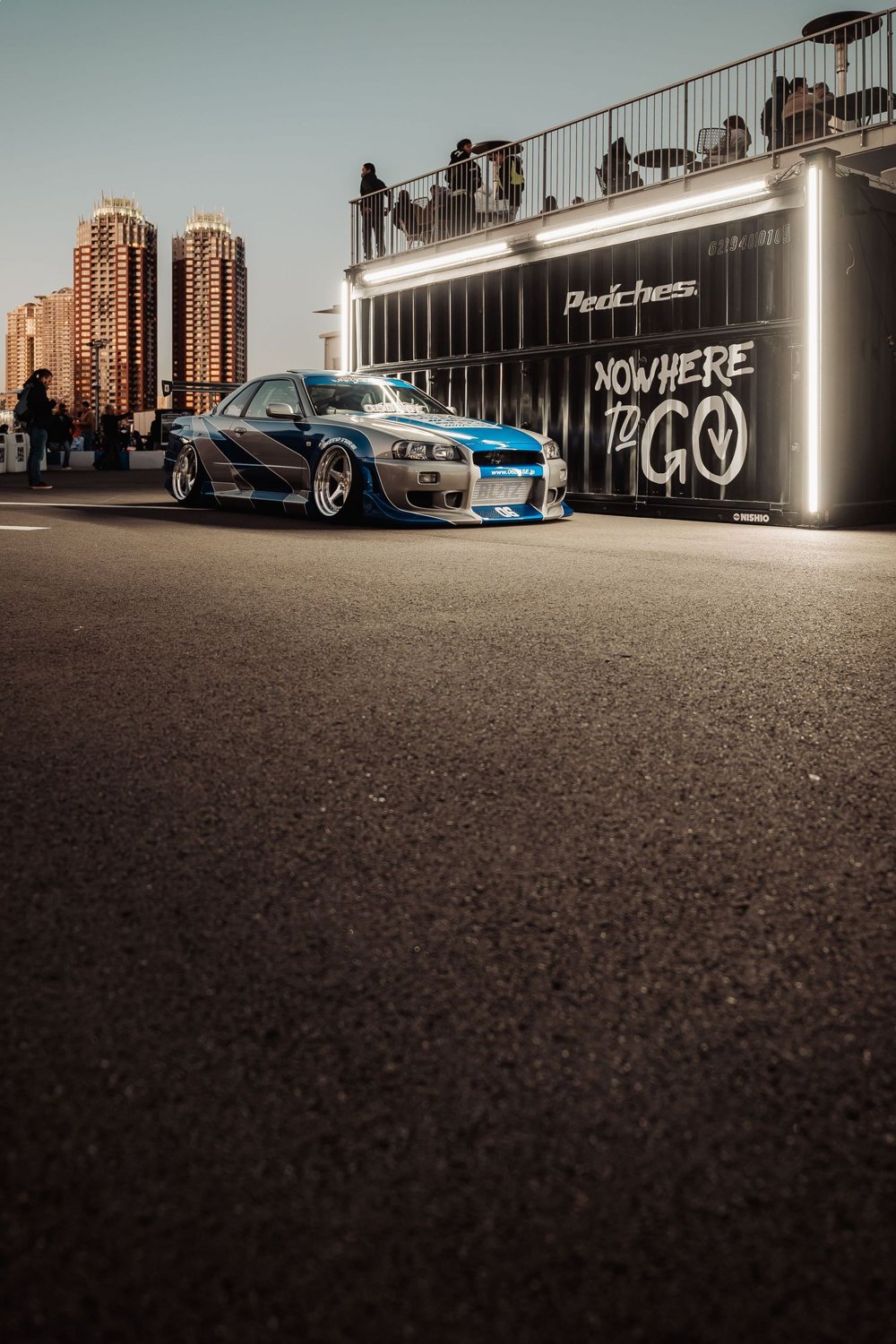 Blauer Nissan Skyline vor dem Peaches-Gebäude in Japan